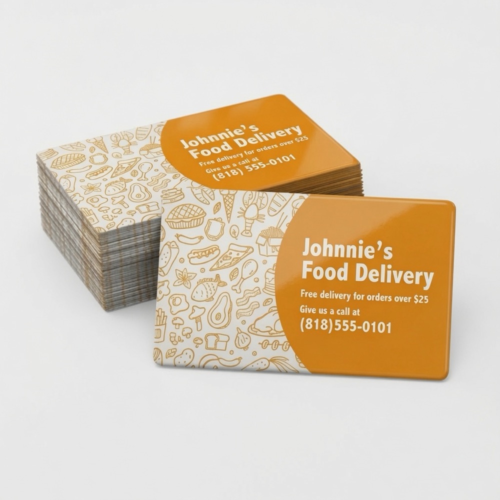 Stack of glossy custom business card magnets for a food delivery business